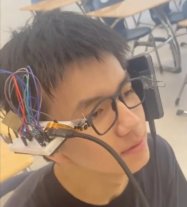 Close-up of the AI glasses being worn, with electronics mounted along the frame